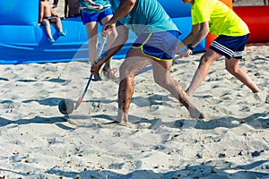 Guys Playing Beach Hokey on Official Competition in Summer on the Sand