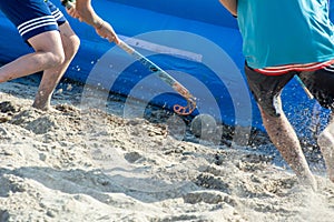 Guys Playing Beach Hokey on Official Competition in Summer on the Sand