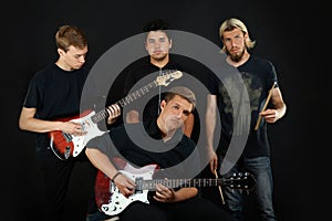 Guys posing with electric guitars