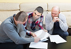 Guys sitting with papers