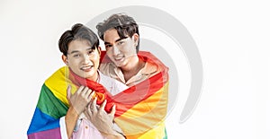 Guys spend time together at home, Portrait of Happy Asian gay couple embracing and showing their love under lgbt colorful rainbow