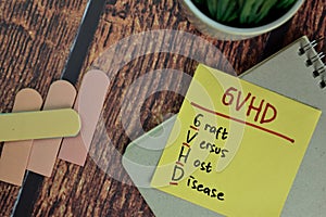 GVHD - Graft Versus Host Disease write on sticky notes isolated on Wooden Table