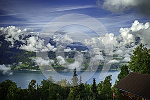 GView of Lake Thun and Bernese Alps including Jungfrau, Eiger and Monch peaks from the top of Niederhorn in summer, Switzerland