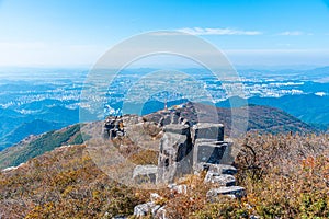 Gwangju viewed behind rocks of Jusangjeolli Cliff at Mudeungsan Mountain, Republic of Korea