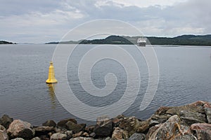 A ferry approaching a port on the coast of Scotland on a cold summers day.