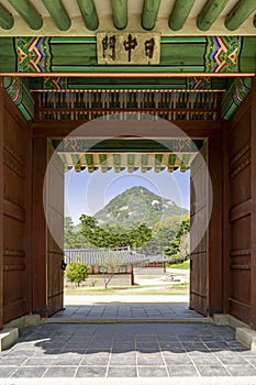 Gyeongbokgung palace in Seoul, South Korea. Door with view on the mountain.
