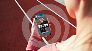 Gym application. Smart phone screen with fitness health or sport gym mobile application. Female hand hold online fitness