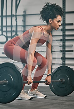 Gym, barbell exercise and black woman doing muscle fitness performance for body health, strength training or