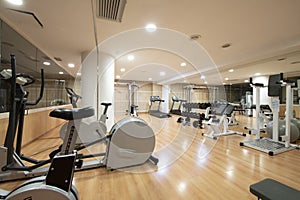 A gym with cardio equipment in the basement