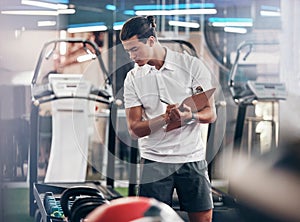 Gym, coach and clipboard with a man manager checking equipment in the gym and writing notes. Leader, personal trainer