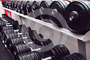 Gym and dumbbell weight training equipment on sport. Healthy life and gym exercise equipments and sports concept.