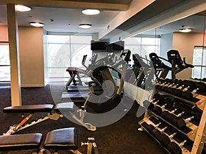 Gym equipment including treadmills and free weights photo
