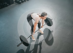 Gym exercise, barbell deadlift and woman doing muscle fitness performance, workout or body building. Strong girl, health