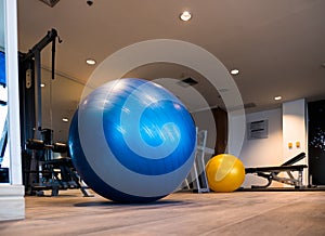 Gym for fitness exercises with aerobic Fitball on the floor.