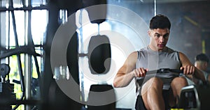 Gym, fitness and man with rowing machine for workout, training and muscle health with challenge, endurance and power