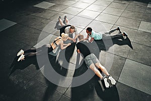Gym friends planking together during a workout class photo