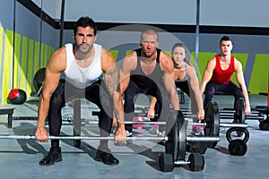 Gym group with weight lifting bar crossfit workout