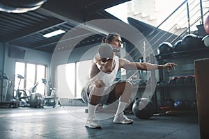 Gym. Man Doing Squats With Kettlebell. Portrait Of Sexy Asian Sportsman Training At Fitness Center.