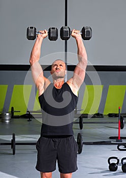 Gym man with dumbbells exercise crossfit