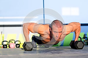 Gym man push-up strength pushup with dumbbell