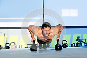 Gym man push-up strength pushup with Kettlebell