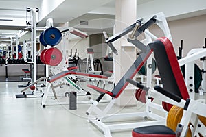 gym modern fitness center room. empty hall with simulators on different muscles.