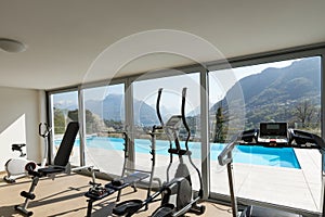 Gym overlooking the pool and hills
