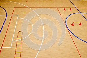 Gym for playing futsal, mini-football. Folded wooden parquet on the field of hall for mini-football. Futsal ball and bright line