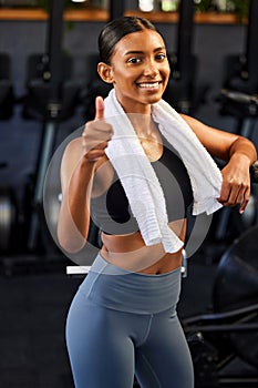 Gym, portrait or happy Indian woman with thumbs up in fitness training with positive mindset or motivation. Wellness