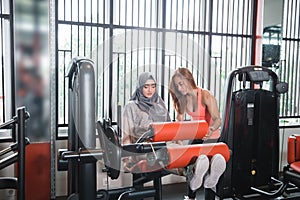 Gym seated leg curl machine exercise muslim women hijab