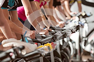 Gym shot - people cycling; spinning class photo