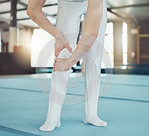 Gym, sport and injury of a professional gymnast suffering from leg pain or ache during training indoors. Sore knee, legs