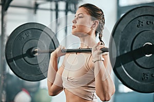 Gym training, barbell workout and woman doing muscle fitness performance, body strength exercise or bodybuilding. Strong