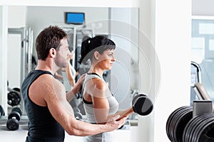 Gym woman personal trainer with weight training