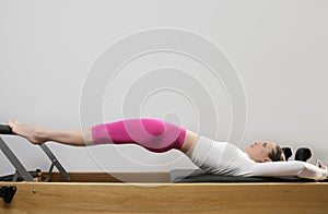 Gym woman pilates stretching sport in reformer bed photo