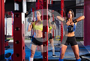 Gym women with barbell and kettlebell workout