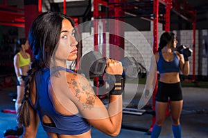 Gym women with hex barbell workout