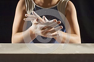 Gymnast Applying White Powder To Hands