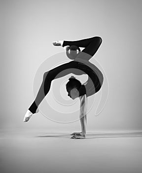 Gymnast in a black suit with a ball