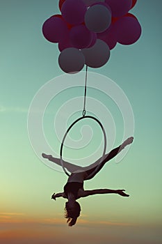 Gymnast girl doing acrobatic tricks on a circle.