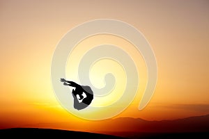 Gymnast jumping in sunset