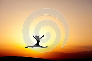 Gymnast jumping in sunset