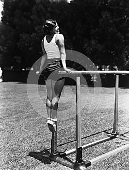 Gymnast on parallel bars outside photo