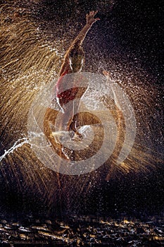 Gymnast in the spray of water