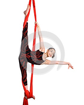 Gymnastic girl exercising on red fabric rope