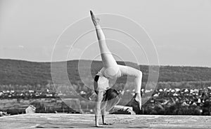 Gymnastics athlete. It never gets easier. Flexible girl outdoor. Woman practicing yoga. Stretching muscles. Fitness