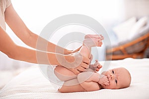 Gymnastics baby. woman doing exercises with child for its development