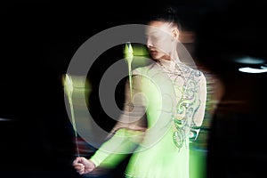 Gymnastics, blur and woman with clubs for dance, rhythmic body movement and training. Black background, health and