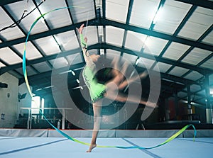 Gymnastics, motion blur and ribbon dance with a woman in a gym training for the olympics competition. Fitness, art and
