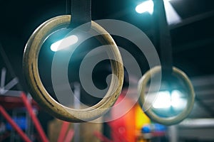 Gymnastics ring, training and equipment in an empty gym for olympics preparation closeup from below. Exercise, health